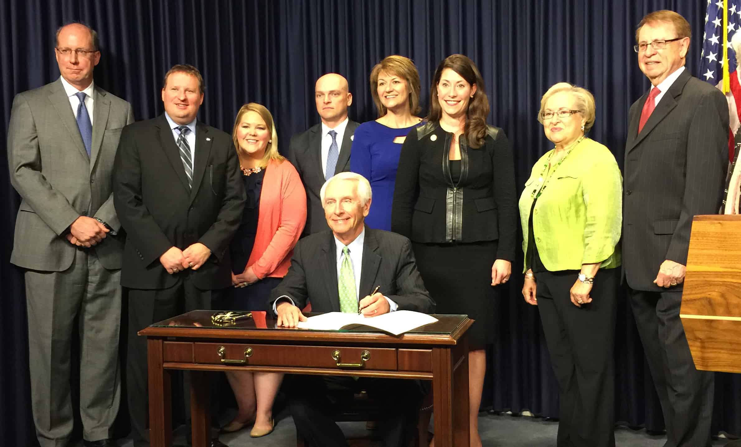 Joining Governor Beshear are (from left to right): Steve Jennings, KNN board member; Bart Baldwin, KNN public policy committee member; Sarah Brandenburg, KNN staff; Noel Caldwell, Executive Director of Kentucky Business One Stop Portal, Secretary of State; Danielle Clore, Executive Director, KNN; Secretary of State Alison Lundergan Grimes, Representative Linda Belcher (D– Shepherdsville); and House Speaker Pro Tem Jody Richards (D–Bowling Green).